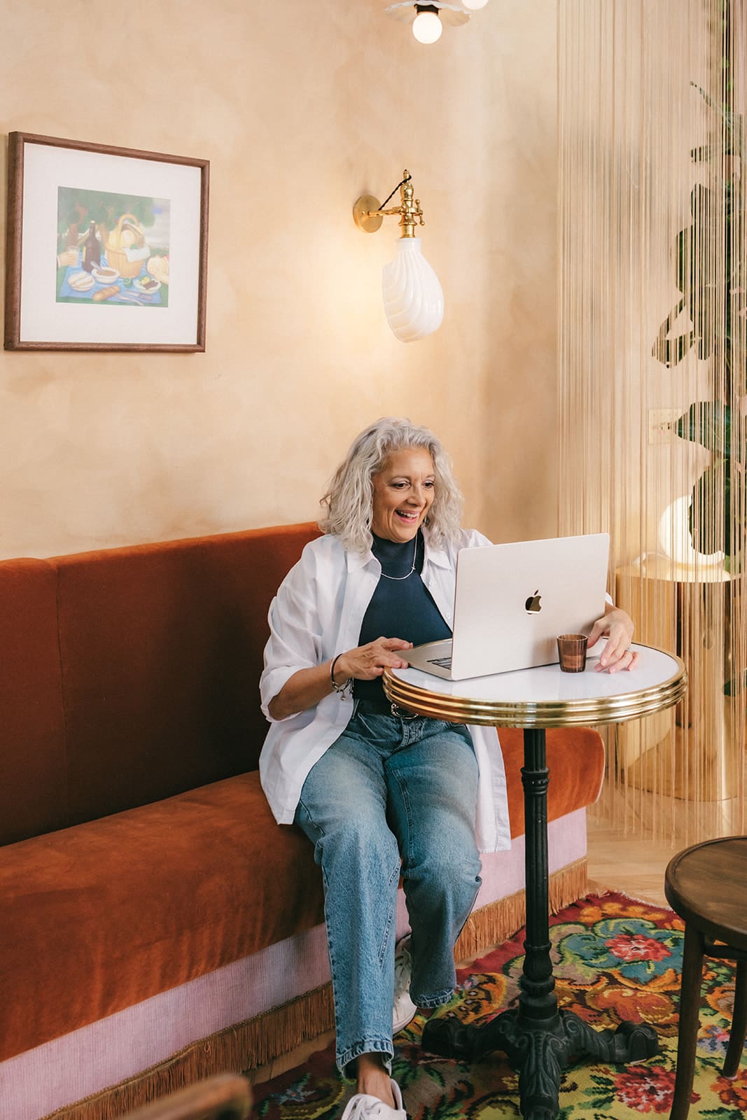 misty hughes Christian life coach sitting at a table with a laptop