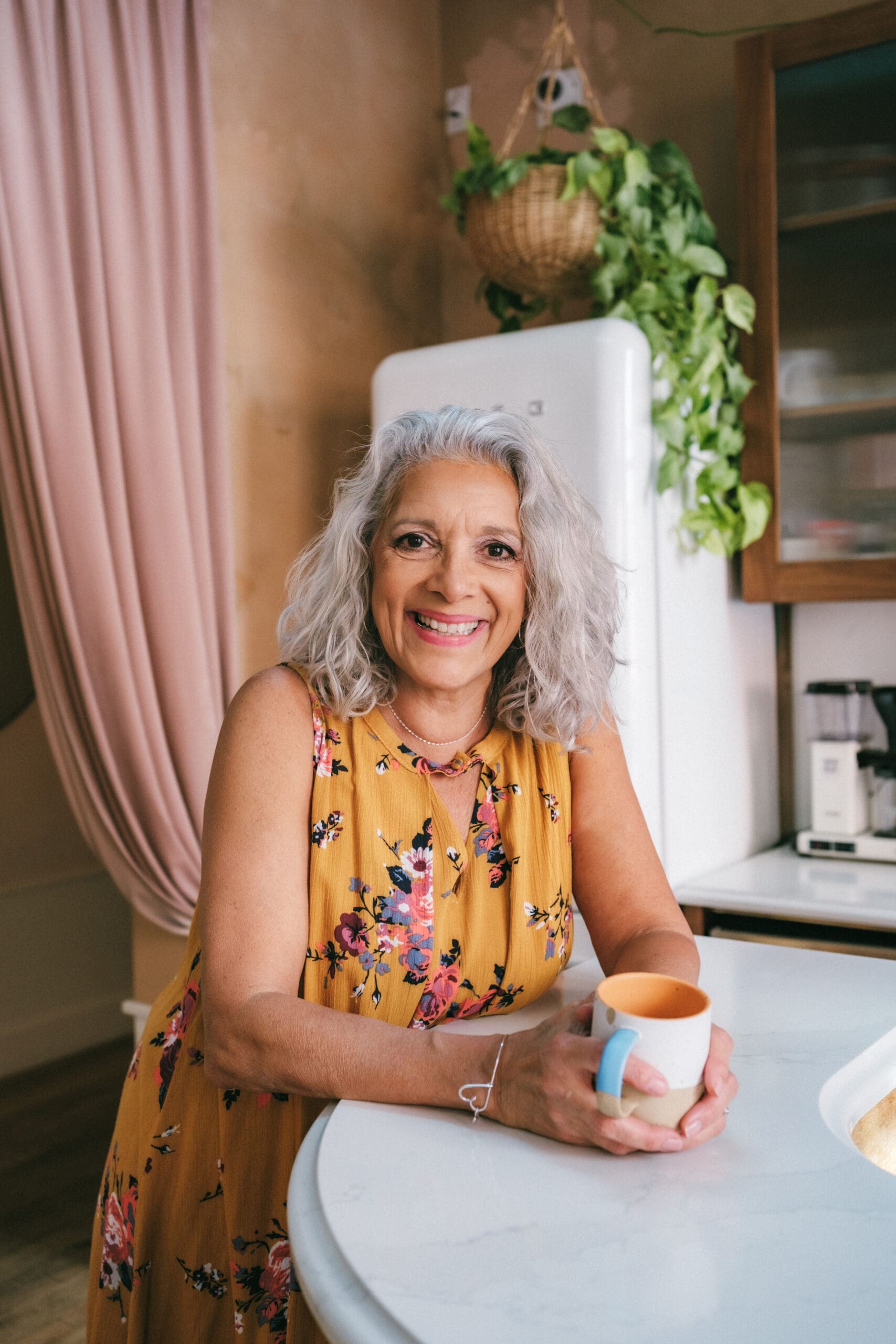 misty hughes standing with a coffee cup in a kitchen counter