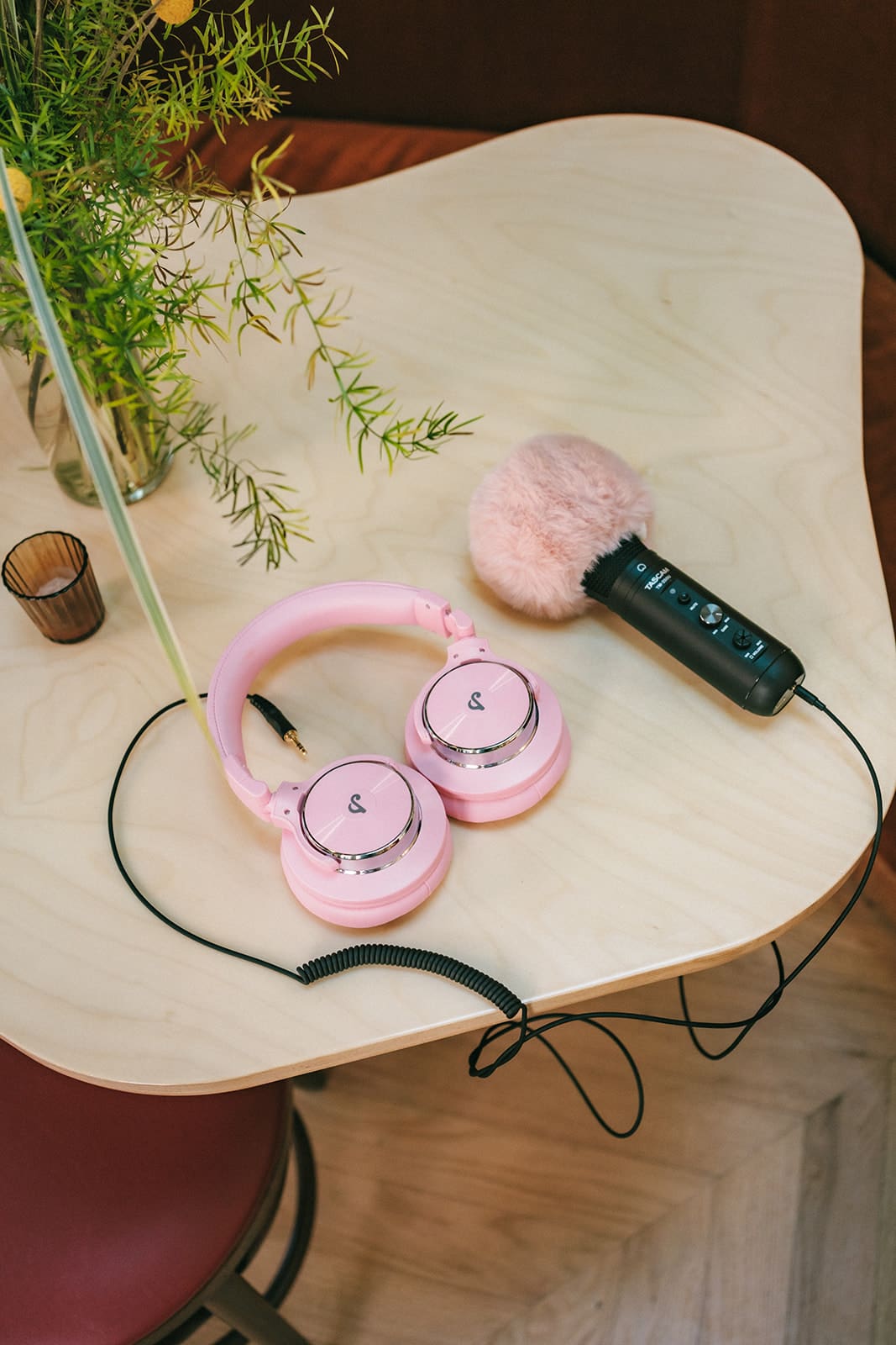 Pink headphones and podcast mic.