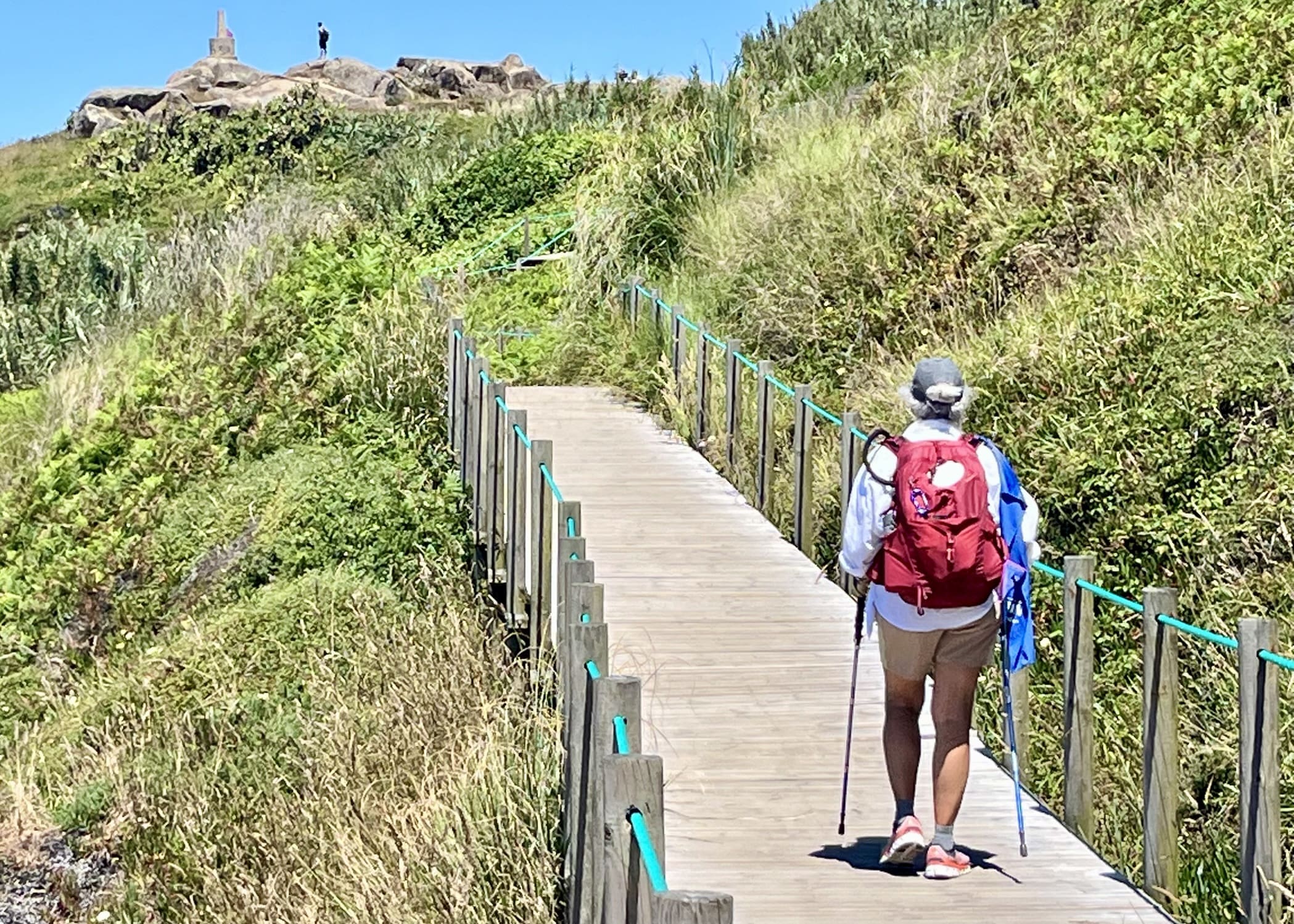 Woman with backpack hiking along a trail