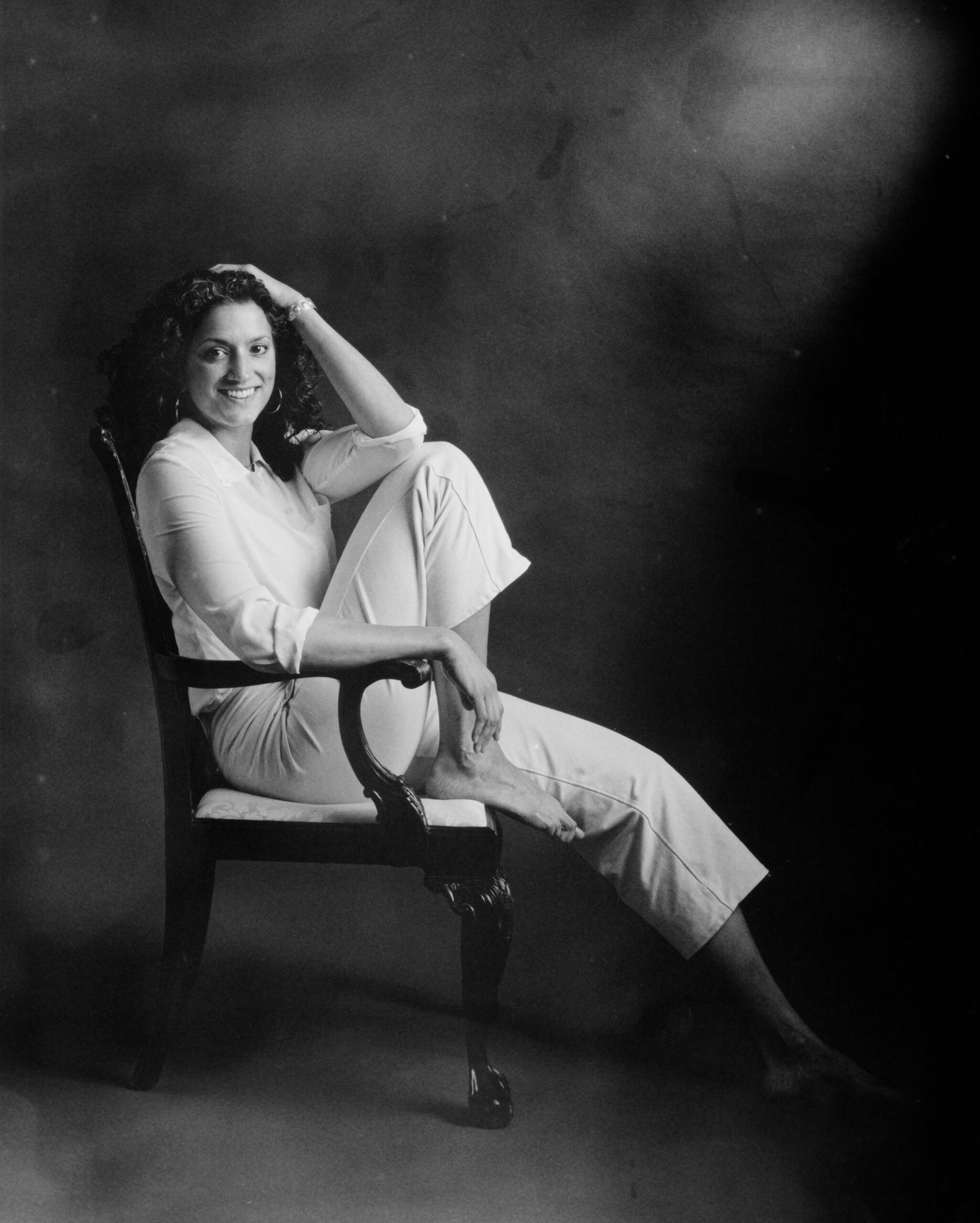 Black and White picture of young woman sitting in chair